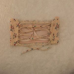 A pink strapless swimsuit top